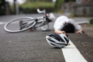 a bicyclist lying in the street after a hit-and-run accident