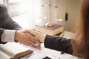 a client shaking hands with his lawyer