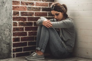 sad abused girl sitting alone