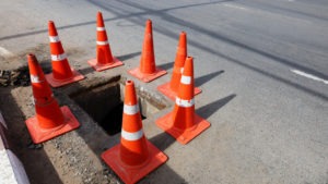 traffic cones around an open manhole