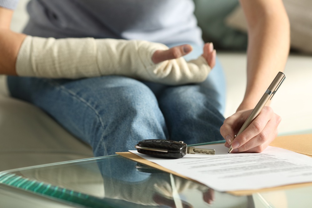 una mujer herida firmando formularios de seguro